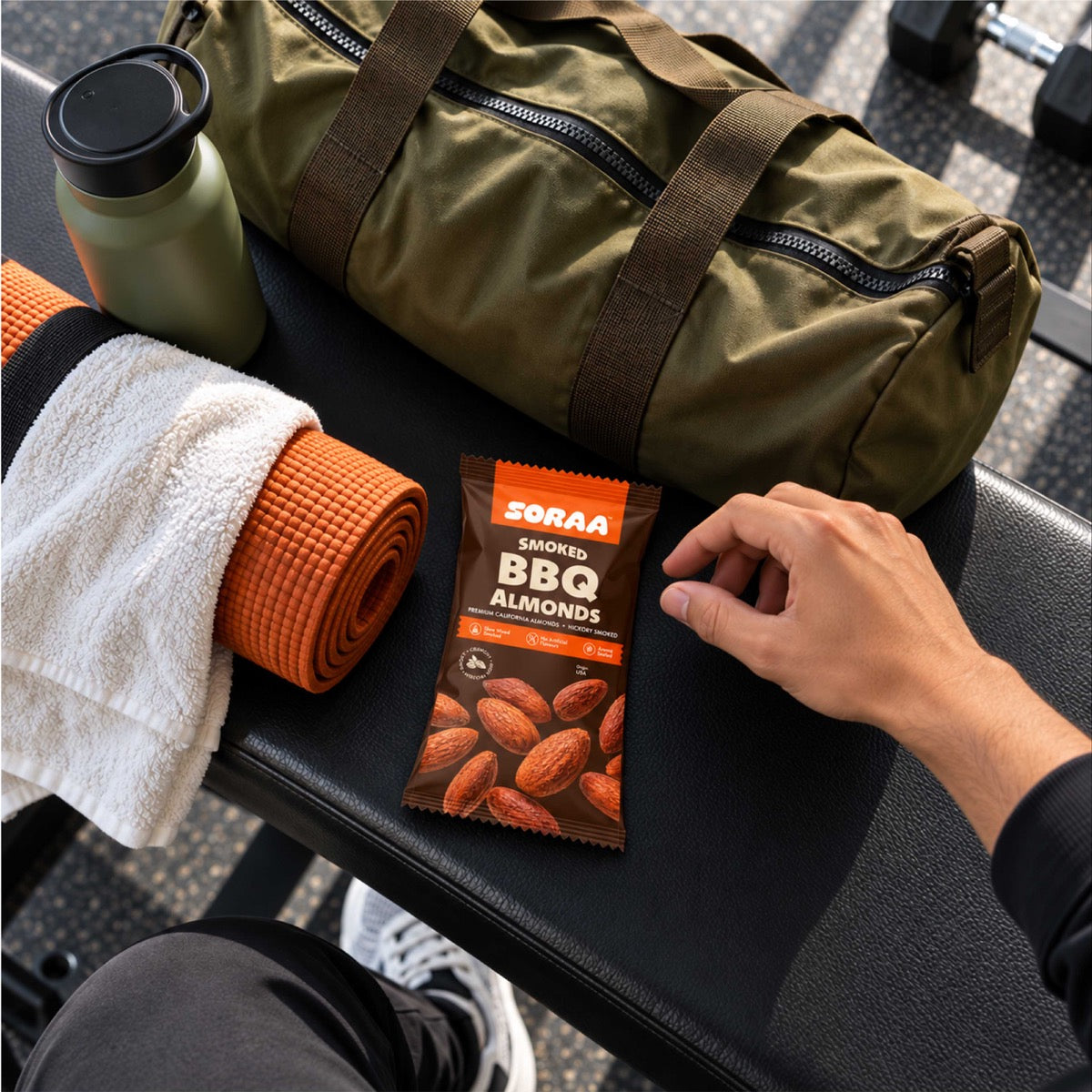 SORAA Smoked BBQ Almonds beside a gym bag and yoga mat